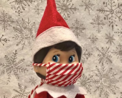 Elf on the Shelf wearing a candy stripe face mask