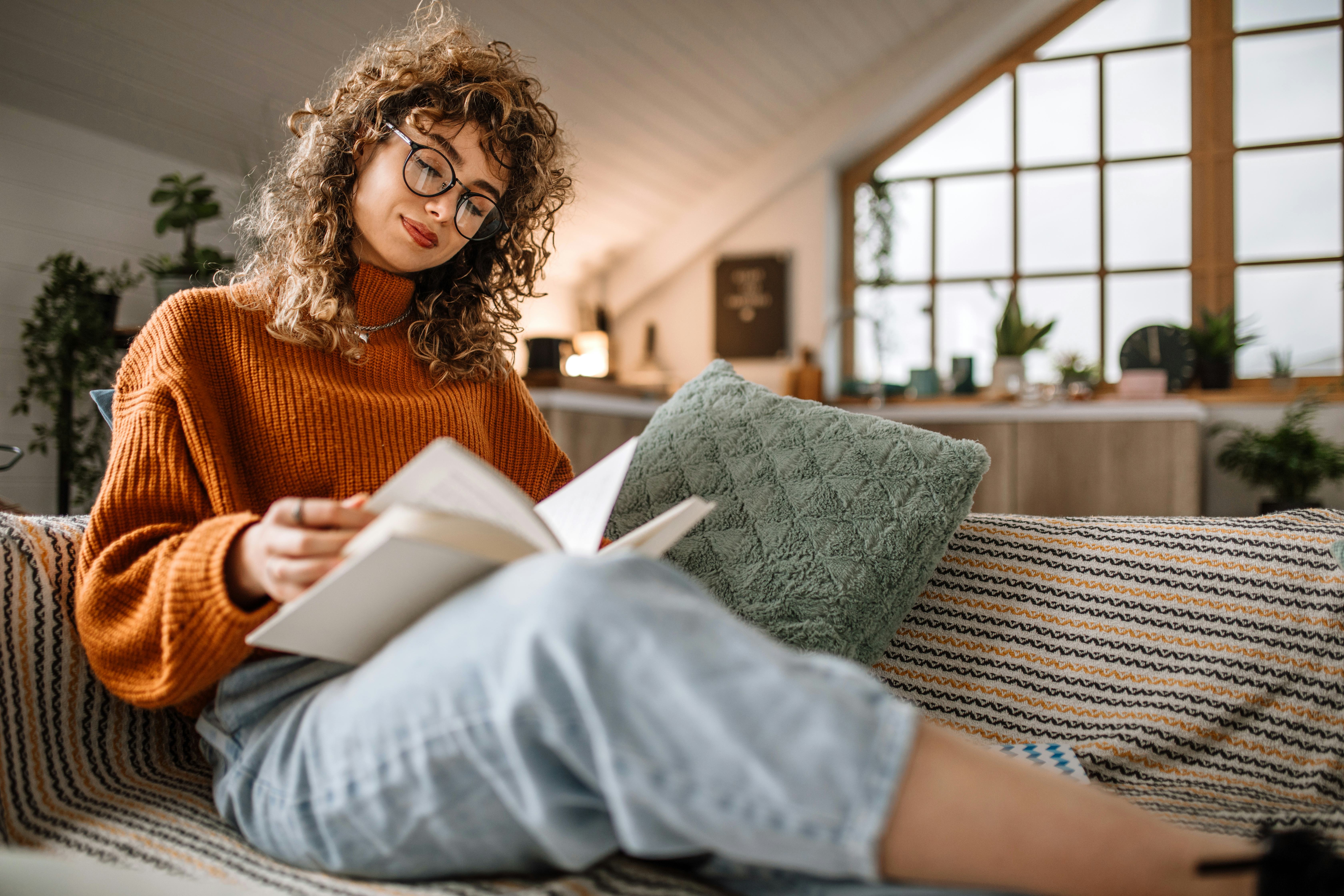 Woman reading on her couch.