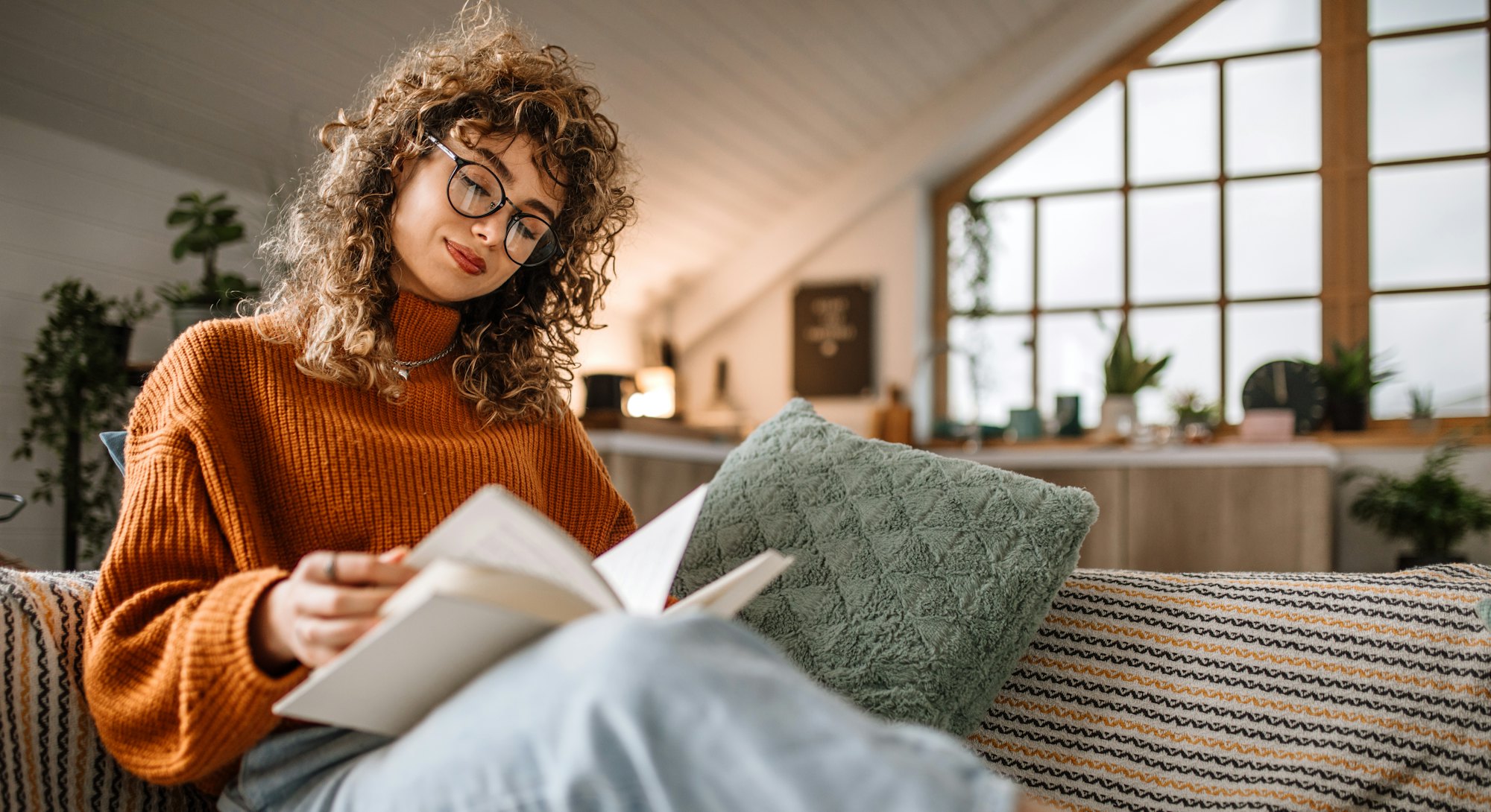 Woman reading on her couch.