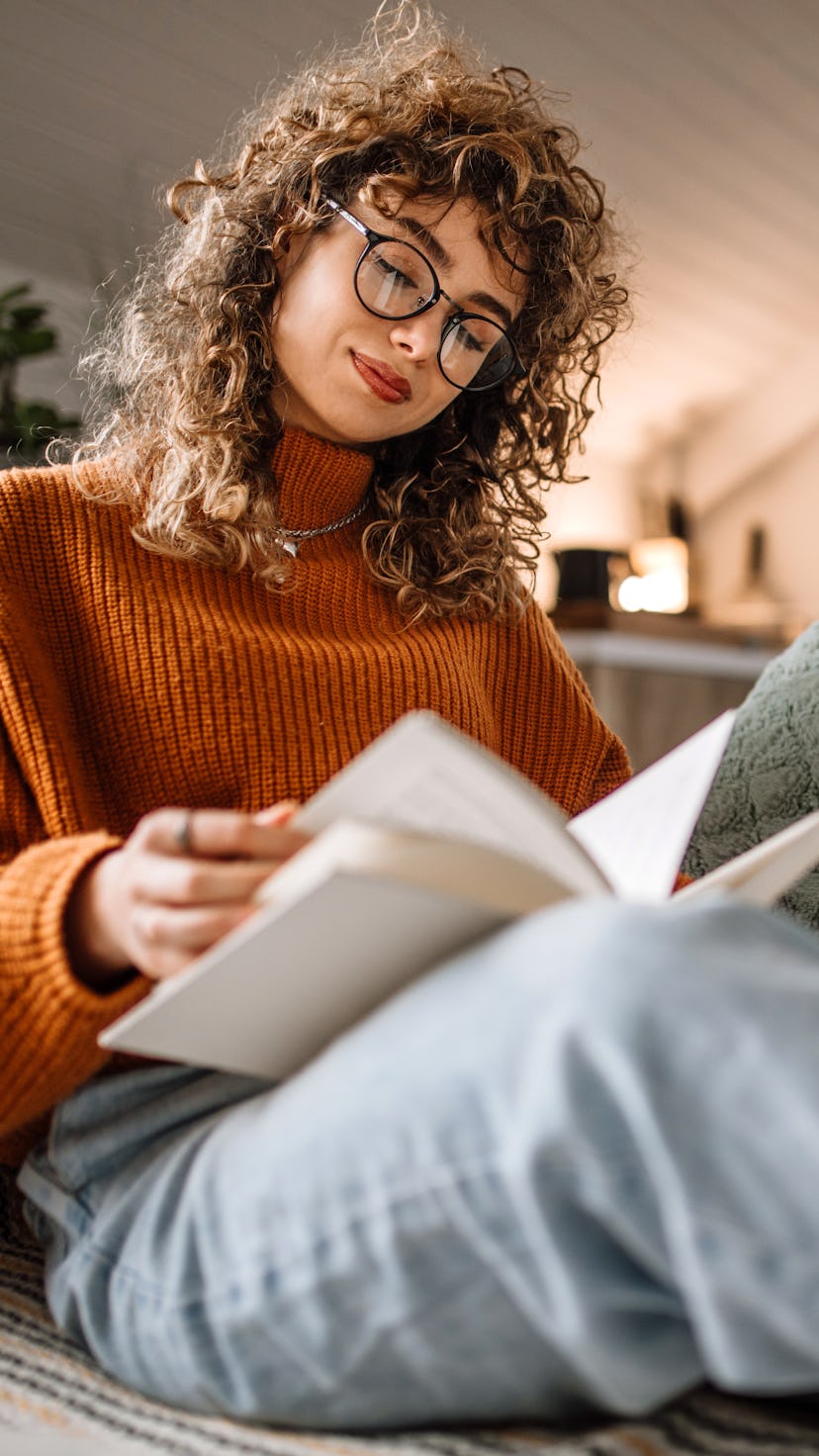 Woman reading on her couch.