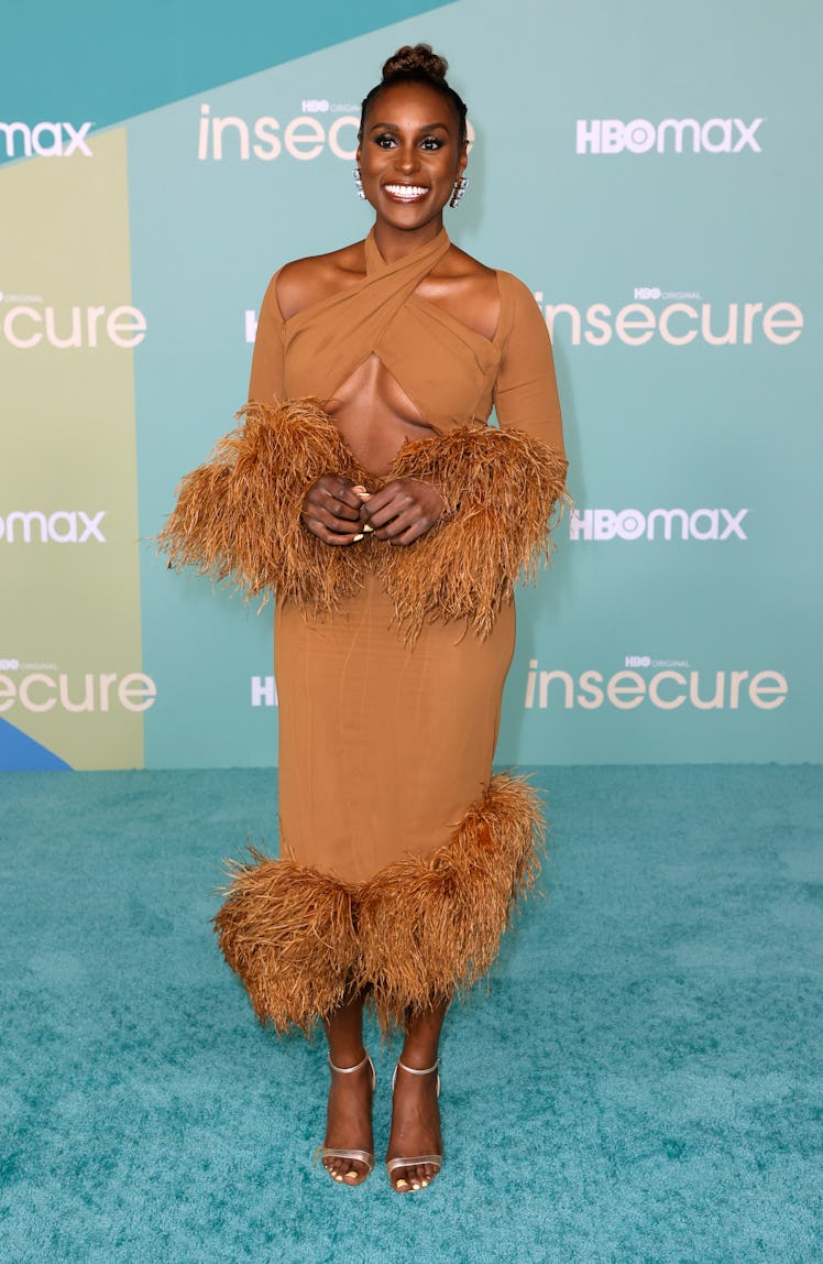 Issa Rae wearing a feathered cutout gown