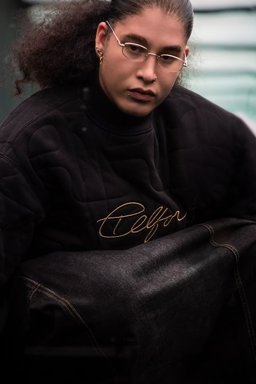 A model in a Moose Knuckles x Telfar jacket dark denim jacket 