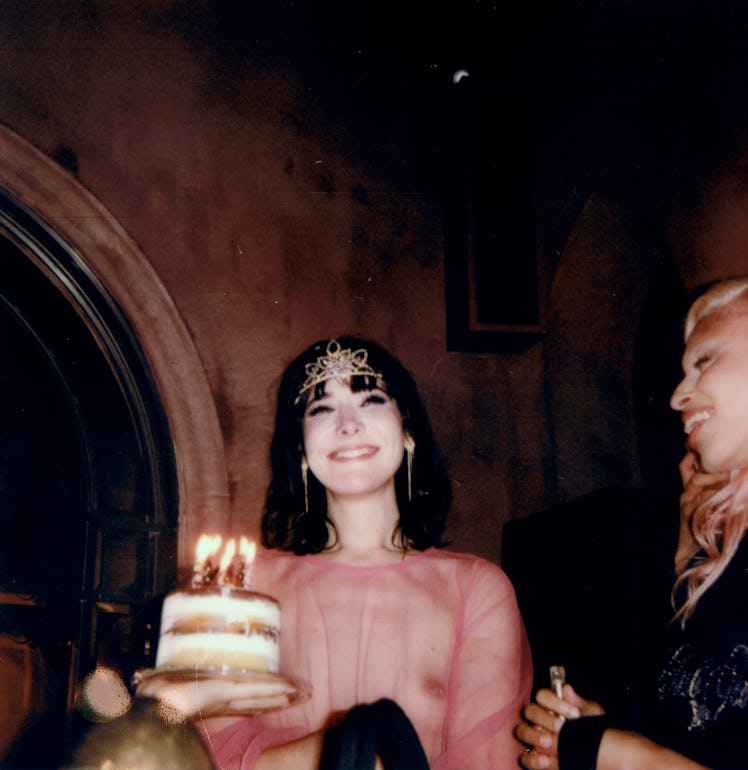 Hari Nef wearing a crown and sheer pink dress