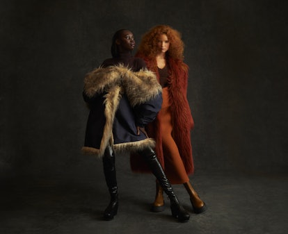 Two models wearing faux fur coats