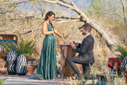 Blake Moynes proposes to lead Katie Thurston in a posed photo taken during the season finale of The ...