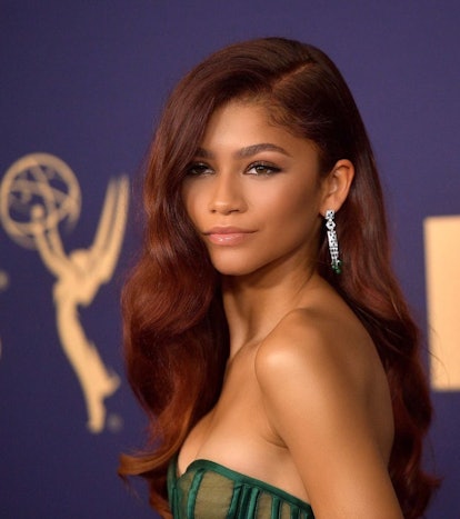 Zendaya with deep red curls on red carpet