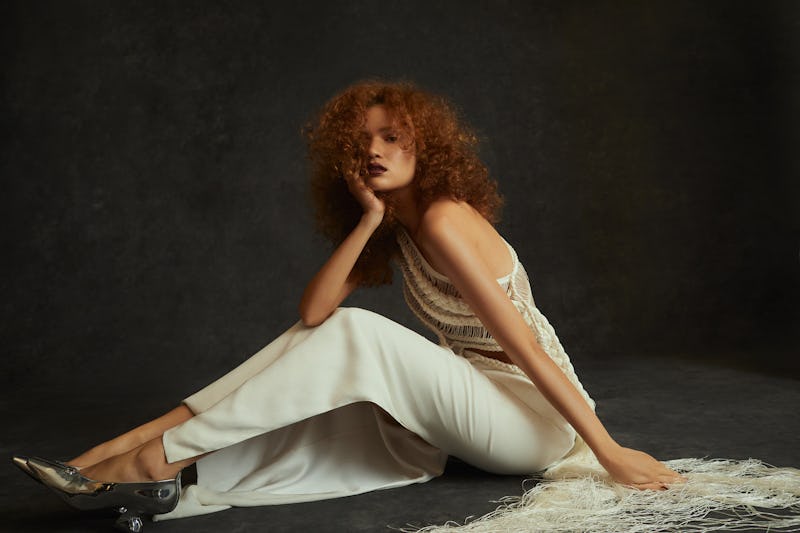 Model wearing white fringe gown