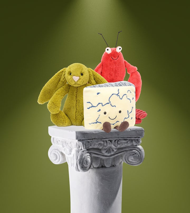 Three characters from jellycat on a pedestal 