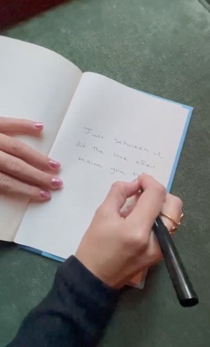 Taylor Swift writing new lyrics with glittery pink nails