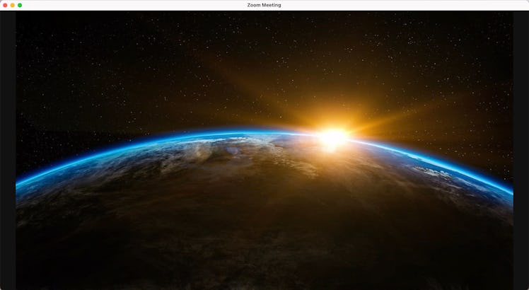 This space Zoom background shows the sunrise over earth. 