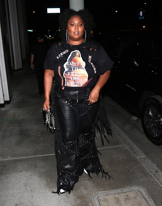Lizzo wears leather fringe pants and a tee in Los Angeles, California. 