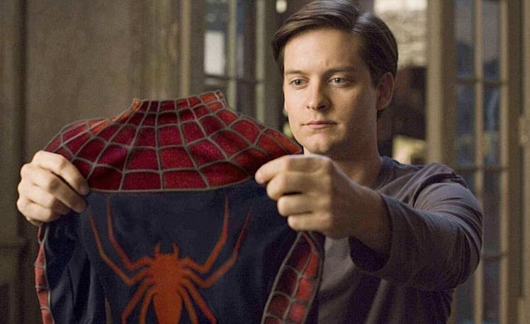 Tobey Maguire holding Spider-Man suit in Spider-Man 2