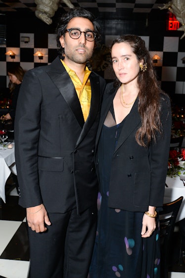 Aaron Aujla in a black suit and yellow shirt and Emily Bode in a black suit and top