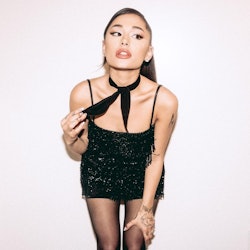 Ariana Grande posing against wall with neckerchief 