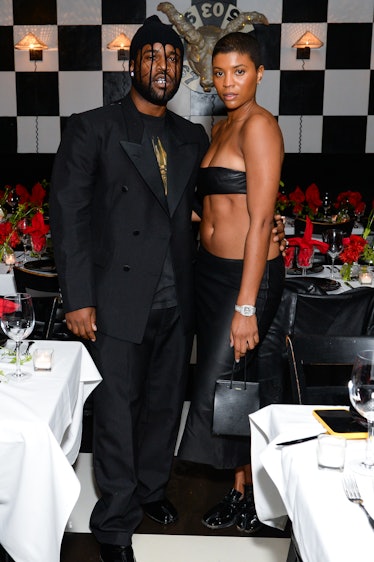 A$AP Ferg in a black suit and shirt and Renell Medrano in a black leather bandeau top and trousers
