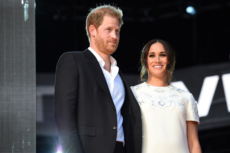 Prince Harry and Meghan Markle at an event holding hands