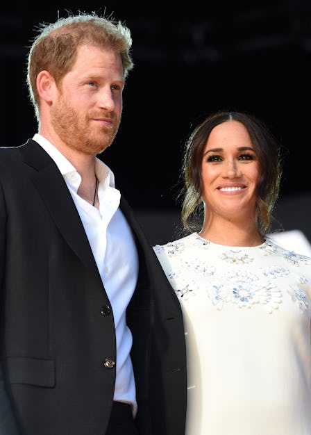 Prince Harry and Meghan Markle at an event holding hands