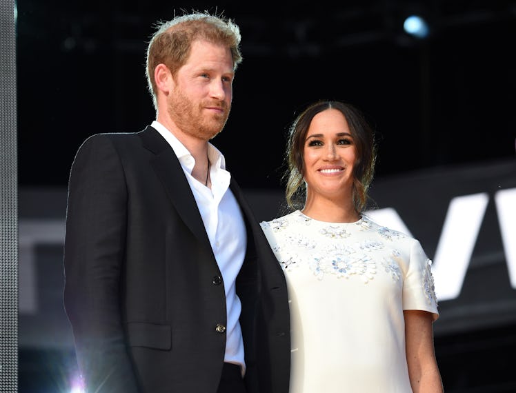 Prince Harry and Meghan Markle at an event holding hands