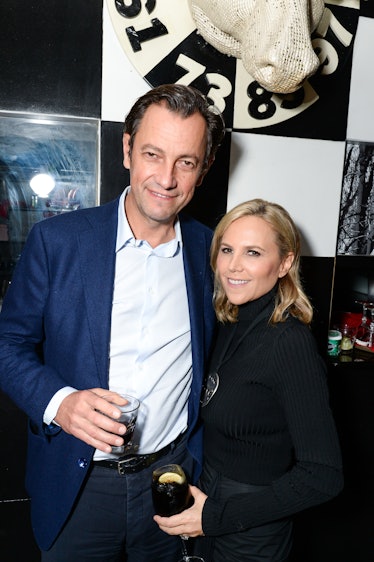 Pierre-Yves Roussel in a navy suit and blue shirt, and Tory Burch in a black dress