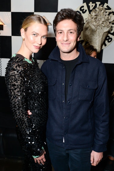 Karlie Kloss in a black lace dress and Josh Kushner in a navy jacket and a black dress