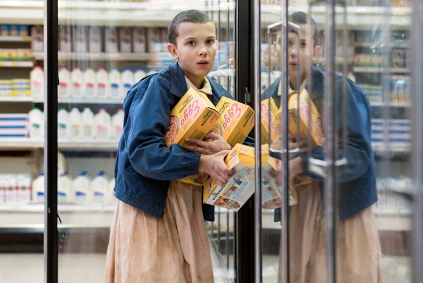 Eleven from Stranger Things steals Eggo Waffles from a grocery store. Classic halloween costume.