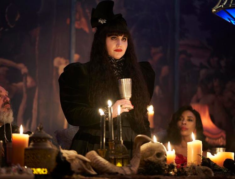 Nadja from What We Do in the Shadows standing with a glass toasting