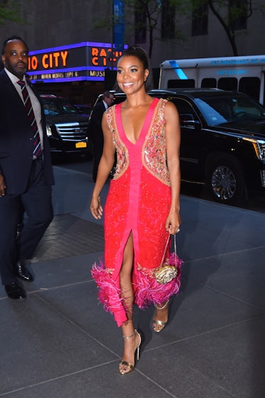 Gabrielle Union in a pink-red sequin and feather dress at the Rockefeller Center