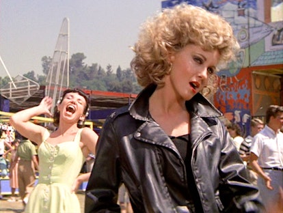 Channel Sandy from 'Grease' as a Halloween costume with a leather jacket.