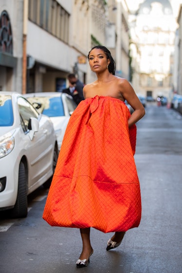 Gabrielle Union in an orange off-the-shoulder dress at the Paris Fashion Week 2020
