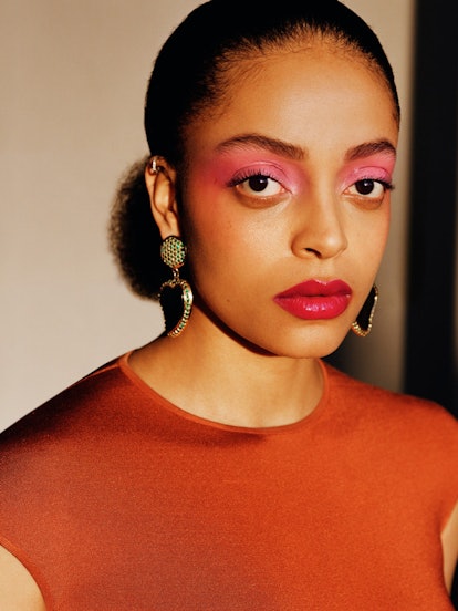 a closeup of a woman wearing pink eye shadow, pink lipstick and blush