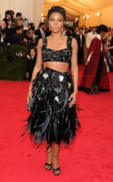 Gabrielle Union in a black crop top and a black sequin and feather skirt at the Met Gala 2014