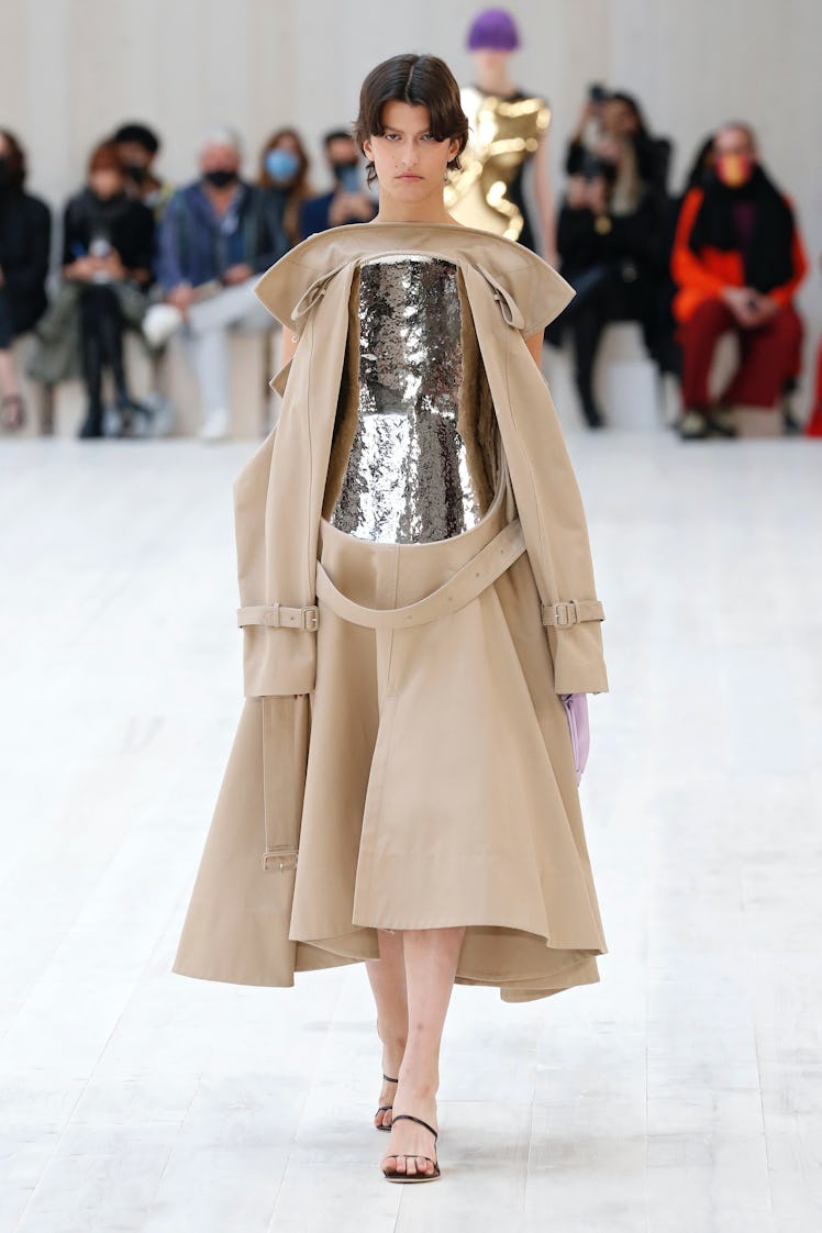 A model walking in a beige-gold dress at the Loewe spring 2022 show at Paris Fashion Week.