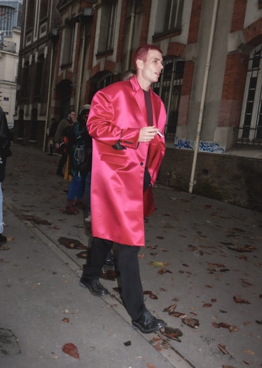 Showgoer at Paris Fashion Week in pink satin coat. 