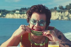 Harry Styles biting into a juicy slice of watermelon in the "Watermelon Sugar" music video.