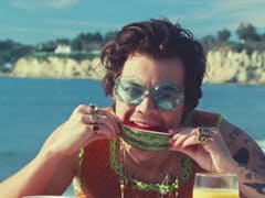 Harry Styles biting into a juicy slice of watermelon in the "Watermelon Sugar" music video.
