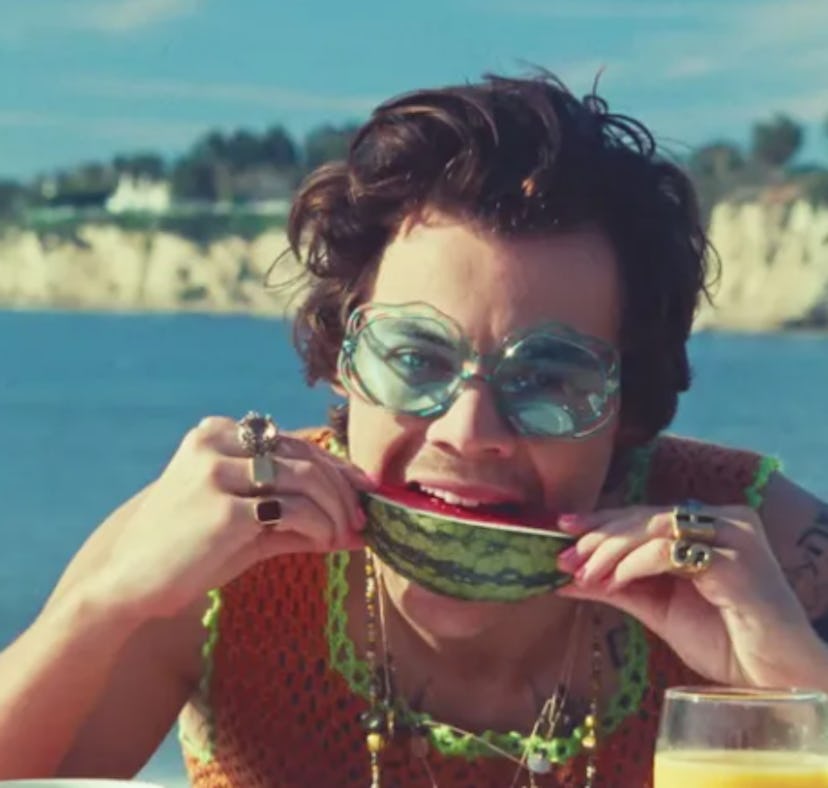 Harry Styles biting into a juicy slice of watermelon in the "Watermelon Sugar" music video.