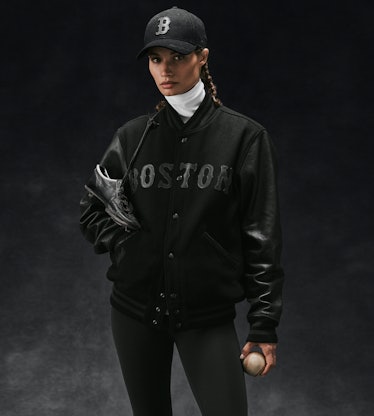 Model in black Boston Red Sox jacket by Ralph Lauren.