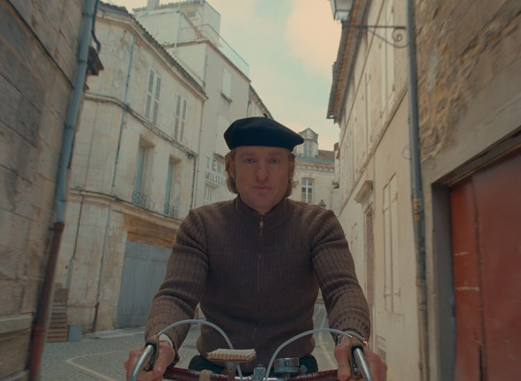 Owen Wilson bikes down a carefully considered street.