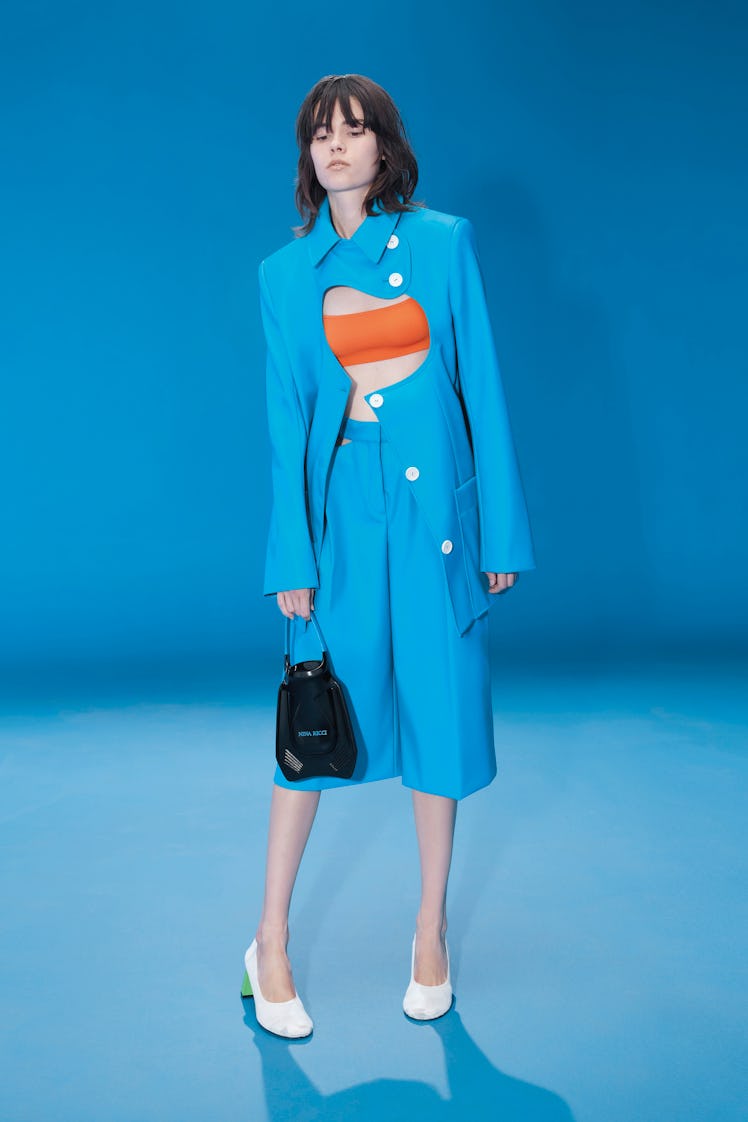 Model wears blue cut out suit from Nina Ricci’s spring 2022 collection.
