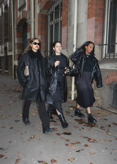 Three showgoers at Paris Fashion Week dressed all in black.