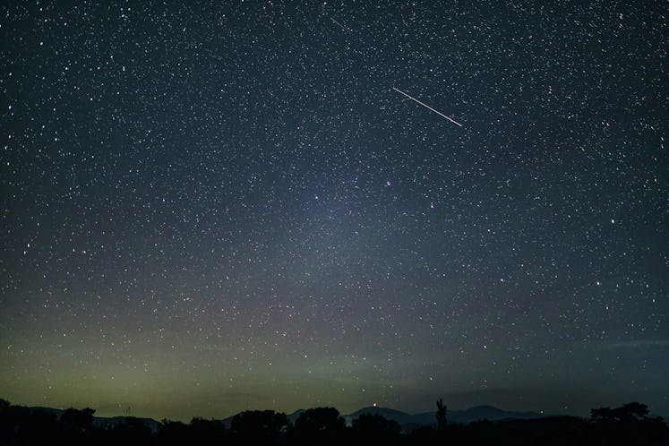 A single meteor in the night sky.