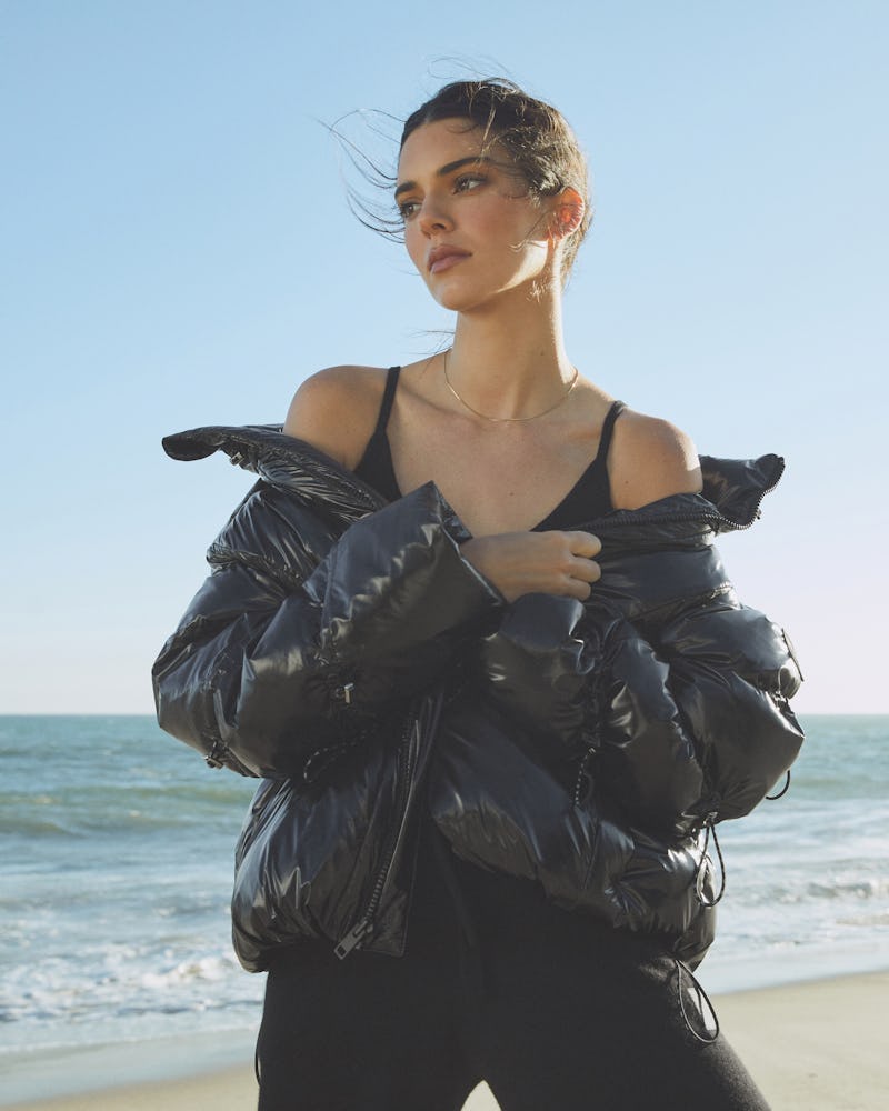 Kendall Jenner wears a black Stunner Puffer jacket from Alo Yoga in her latest campaign, released on...