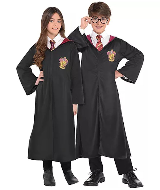 Boy and girl modeling Harry Potter costume robes
