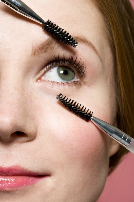 Woman using lash wands around eyes
