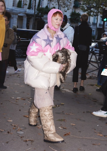 Courtney Trop in starred puffer coat, pink bonnet at the Miu Miu spring 2022 show at Paris Fashion W...