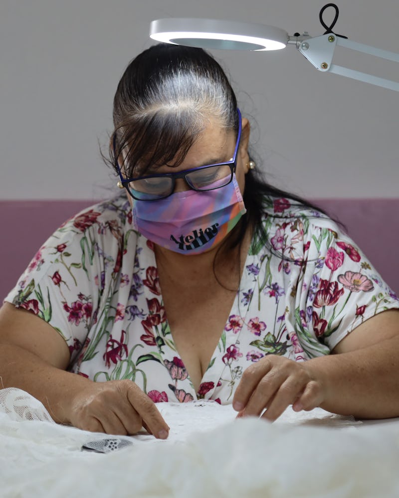 Lupita Jaimes Sedano working on a dress.