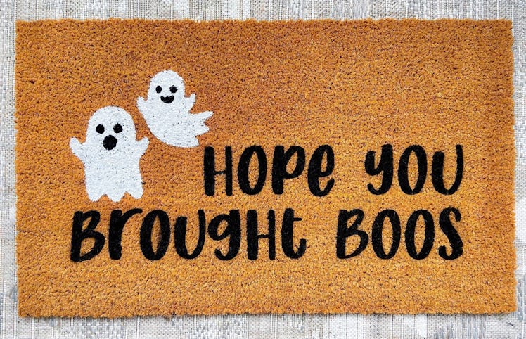 These Halloween doormats include hand painted designs from Etsy.