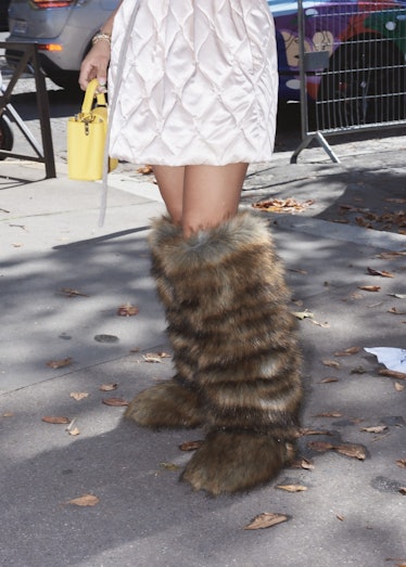 Showgoer in fuzzy Yeti boots outside the Miu Miu spring 2022 show at Paris Fashion Week.