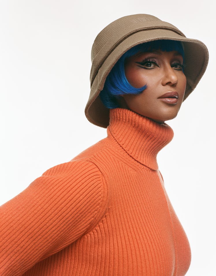 Iman wears a Marc Jacobs sweater and hat. 