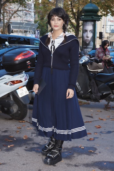 Maria Bernad in navy sailor skirt and top outside Miu Miu spring 2022 show at Paris Fashion Week.